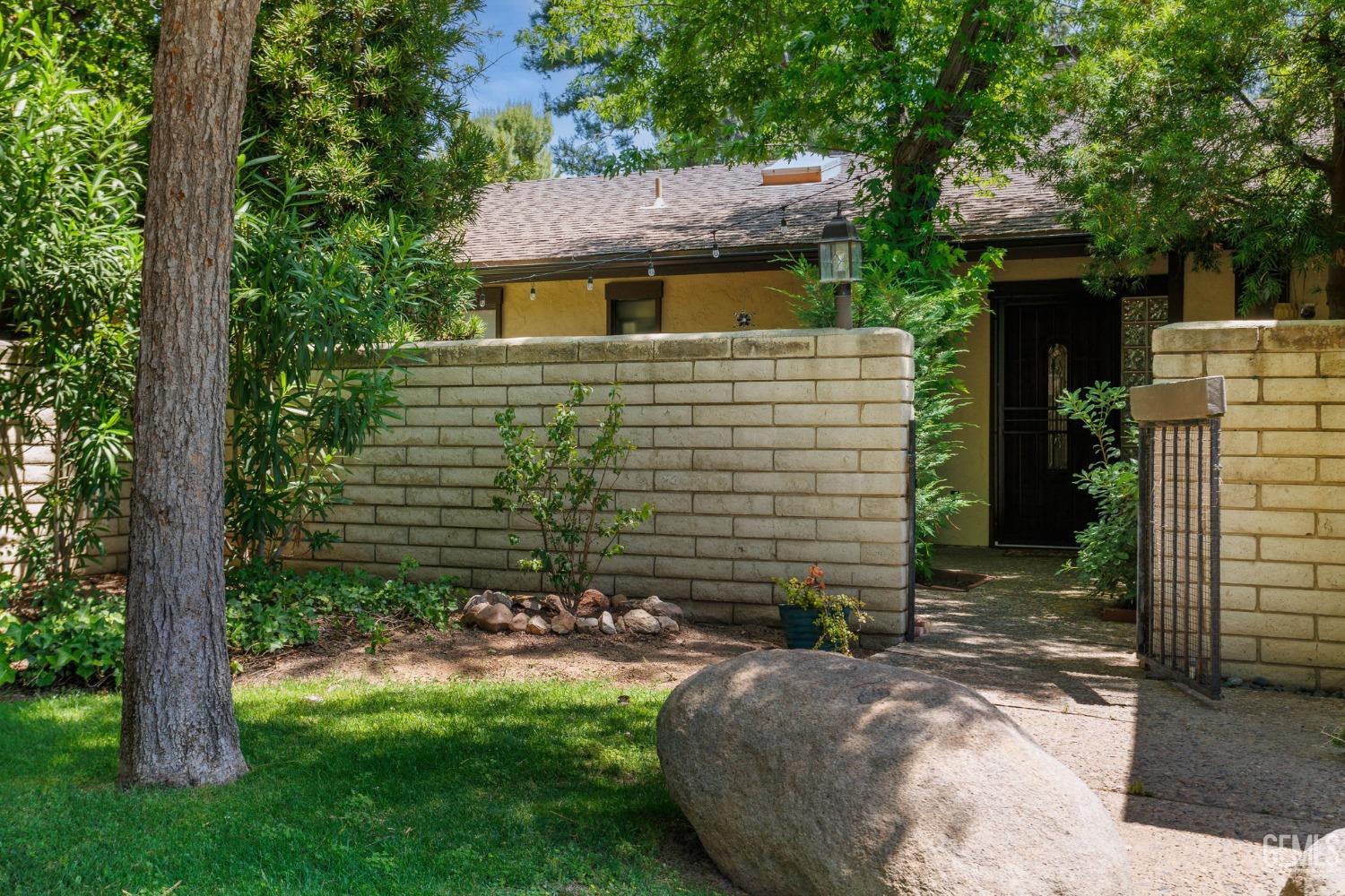 Undisclosed Address Bakersfield, CA 93306 - Photo 6 of 61 a view of a backyard with plants and large trees