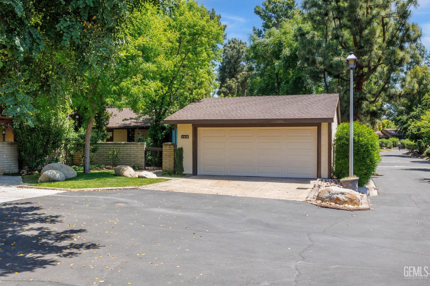 Undisclosed Address Bakersfield, CA 93306 - Photo 61 of 61 a front view of a house with a yard and garage