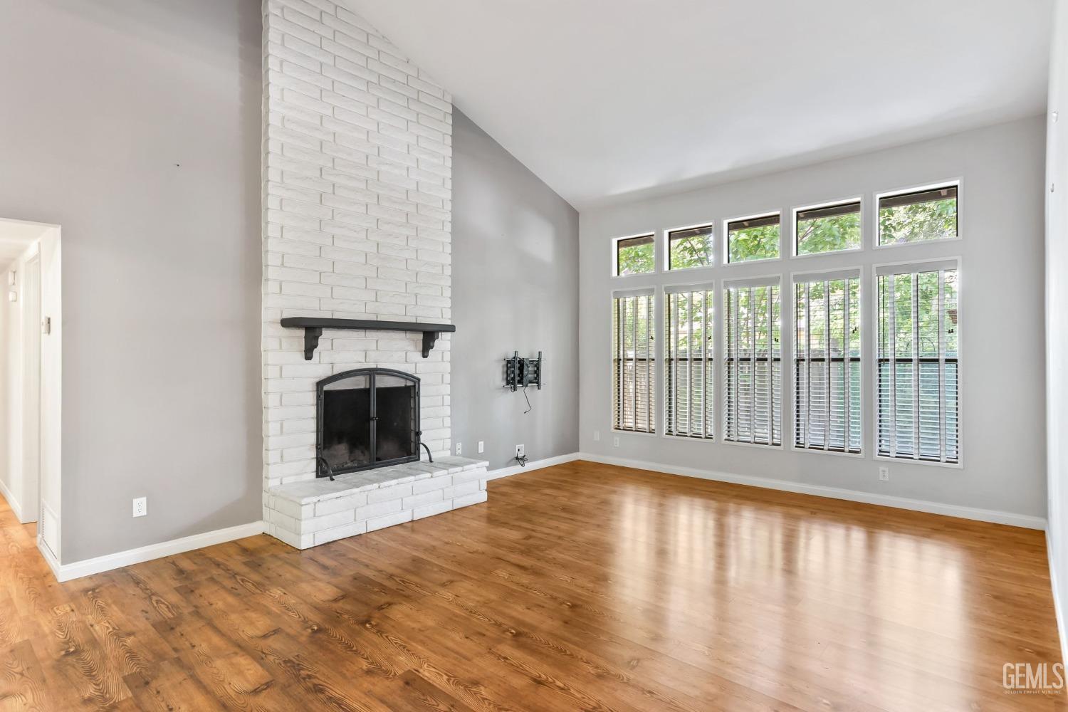 Undisclosed Address Bakersfield, CA 93306 - Photo 9 of 61 a view of an empty room with a fireplace and a window