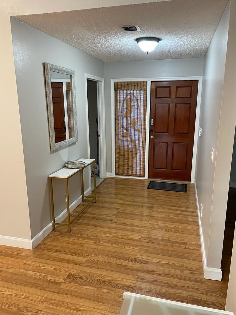 a view of a livingroom with an empty space and a ceiling fan