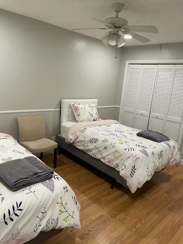 a bedroom with a bed and a ceiling fan