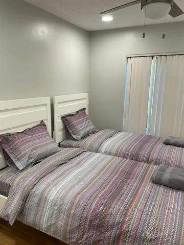 a bedroom with two beds and a lamp