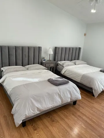 a bedroom with a bed and a night stand