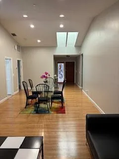 a dining room with furniture and wooden floor