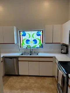 a kitchen with a sink a stove and a microwave