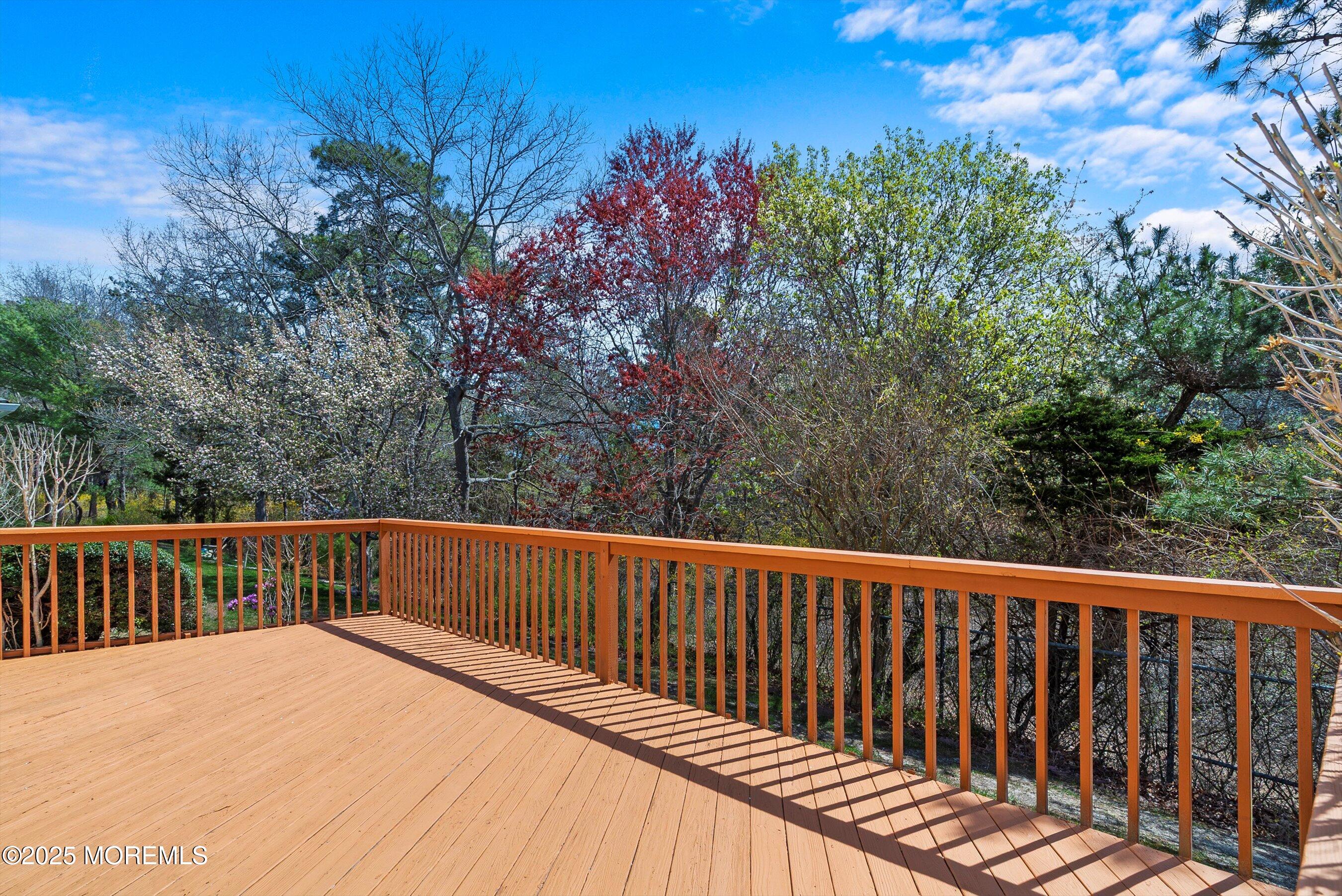 32 Pine Oak Boulevard Barnegat, NJ 08005 - Photo 14 of 40 a balcony with wooden floor and trees in the background