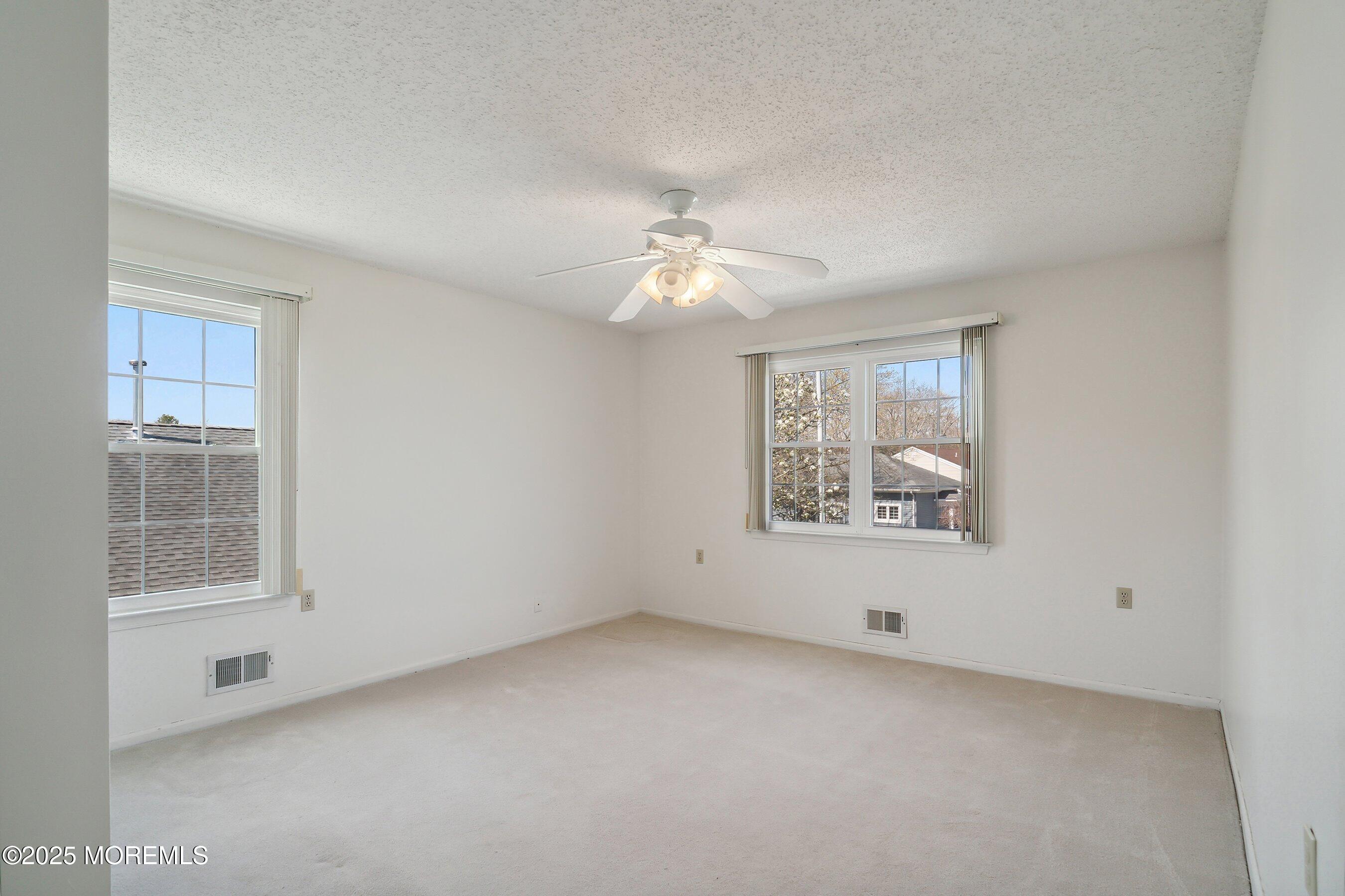 32 Pine Oak Boulevard Barnegat, NJ 08005 - Photo 29 of 40 an empty room with windows and fan