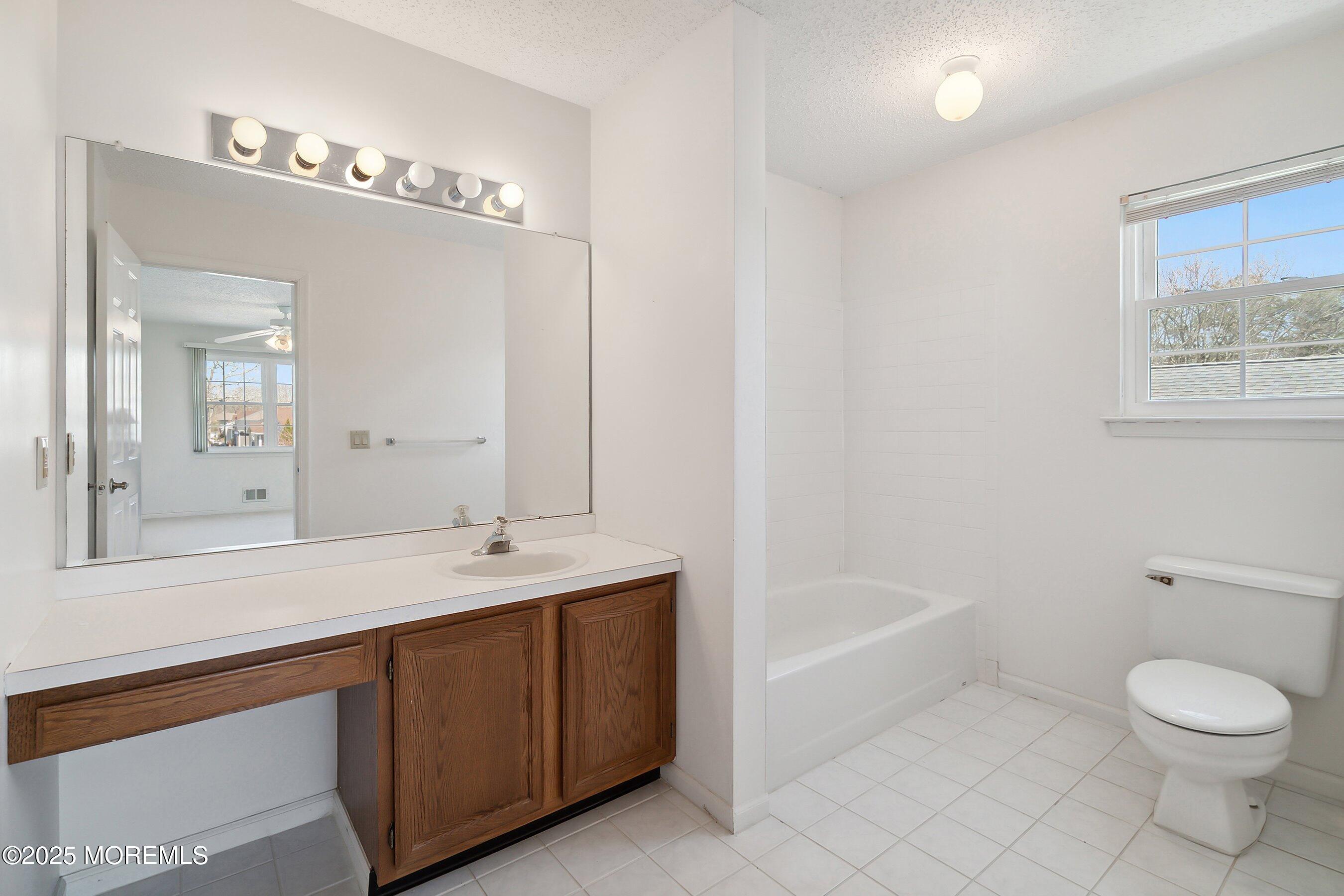 32 Pine Oak Boulevard Barnegat, NJ 08005 - Photo 30 of 40 a bathroom with a sink a toilet and a mirror