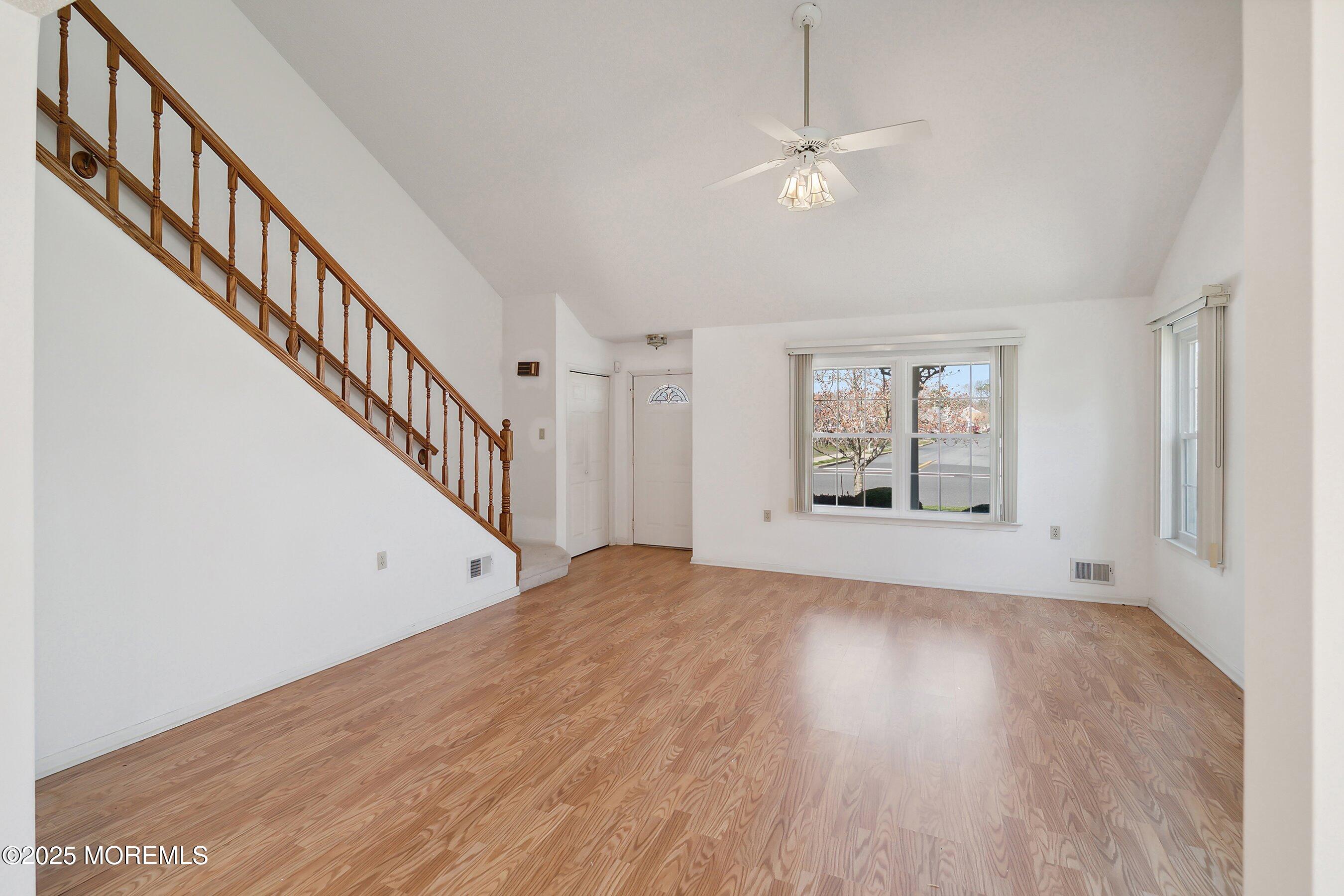 32 Pine Oak Boulevard Barnegat, NJ 08005 - Photo 6 of 40 a view of an empty room with wooden floor and stairs