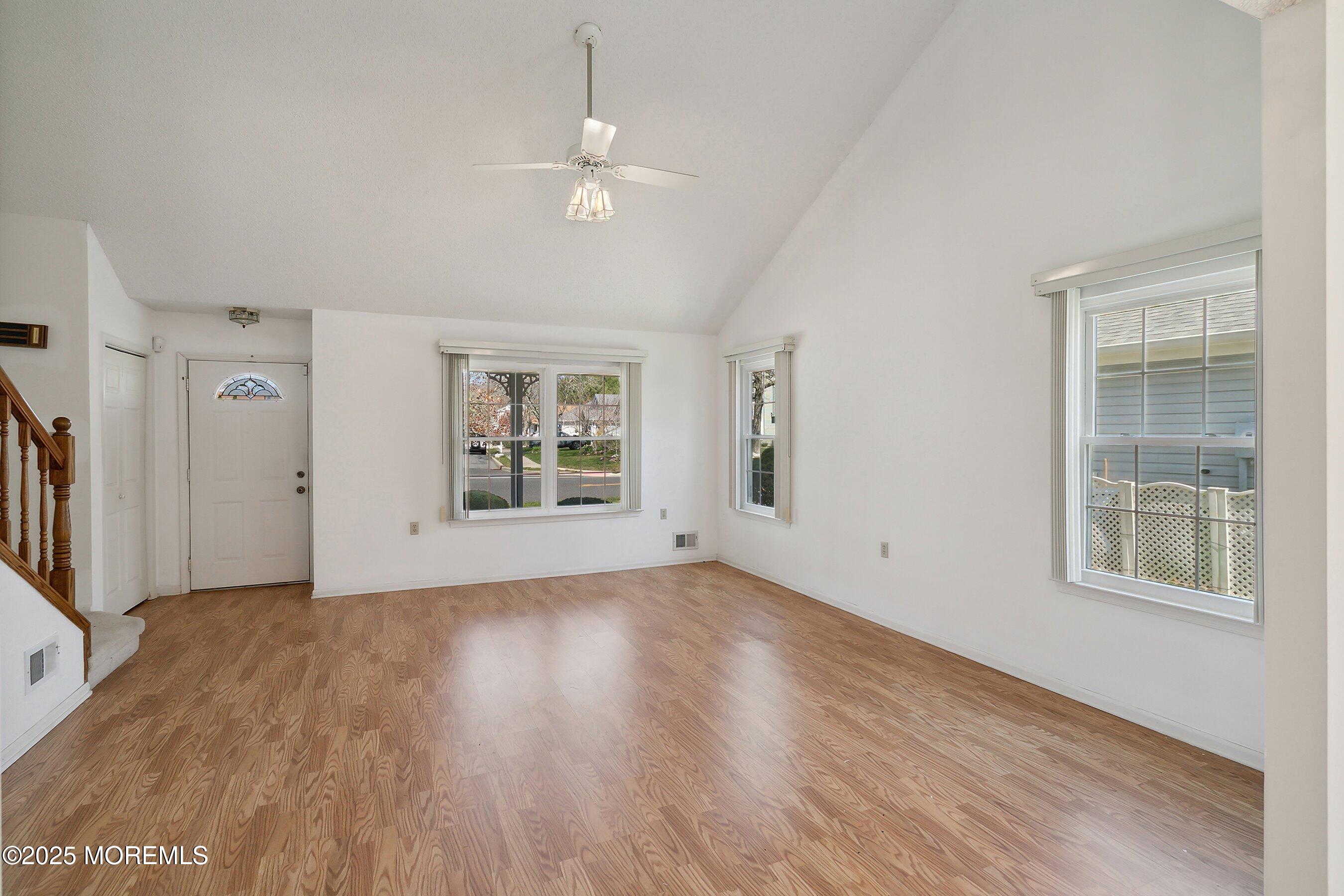 32 Pine Oak Boulevard Barnegat, NJ 08005 - Photo 7 of 40 a view of an empty room with a window and wooden floor