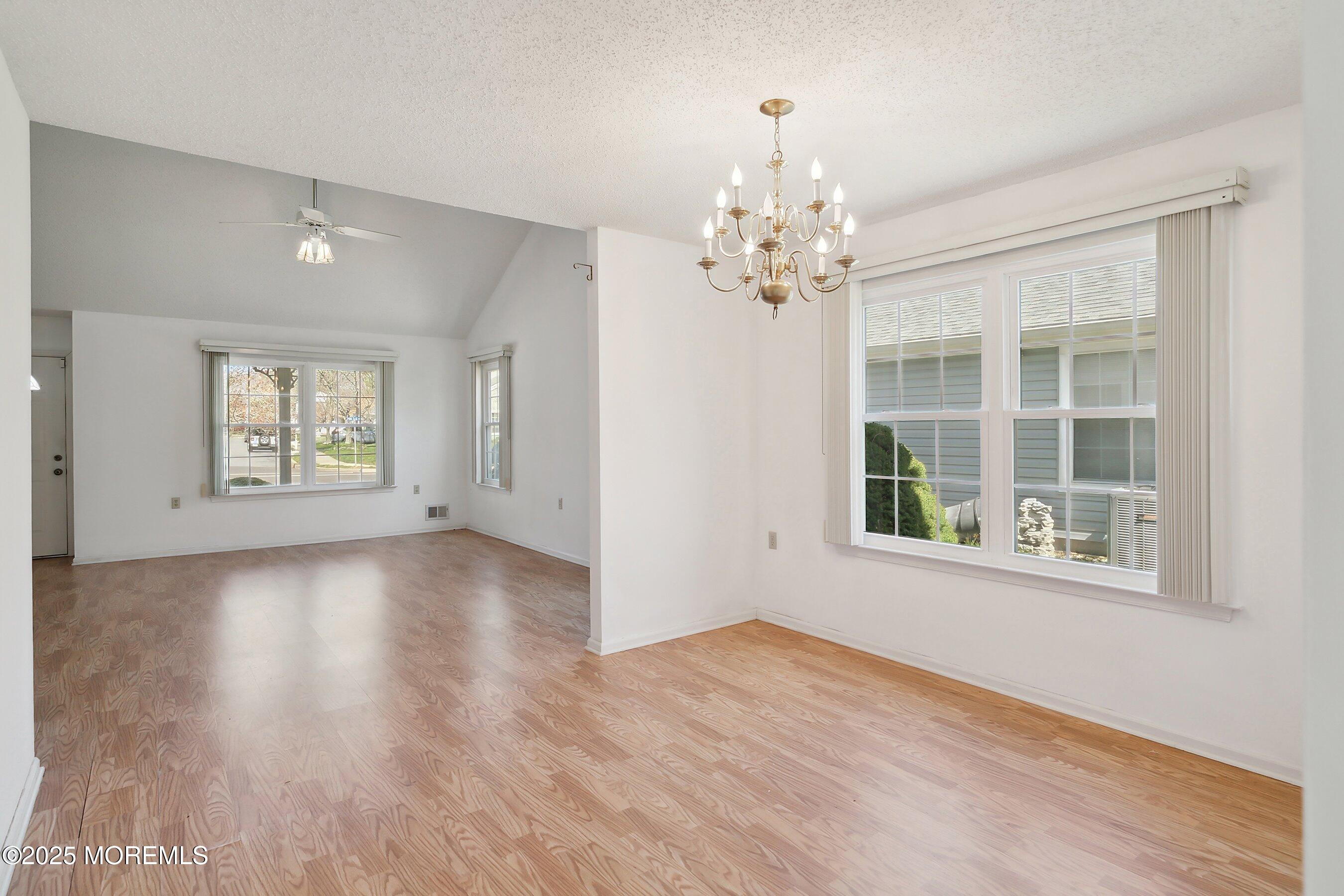 32 Pine Oak Boulevard Barnegat, NJ 08005 - Photo 10 of 40 an empty room with wooden floor and windows