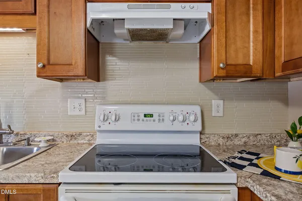 a view of an empty room with window and cabinet