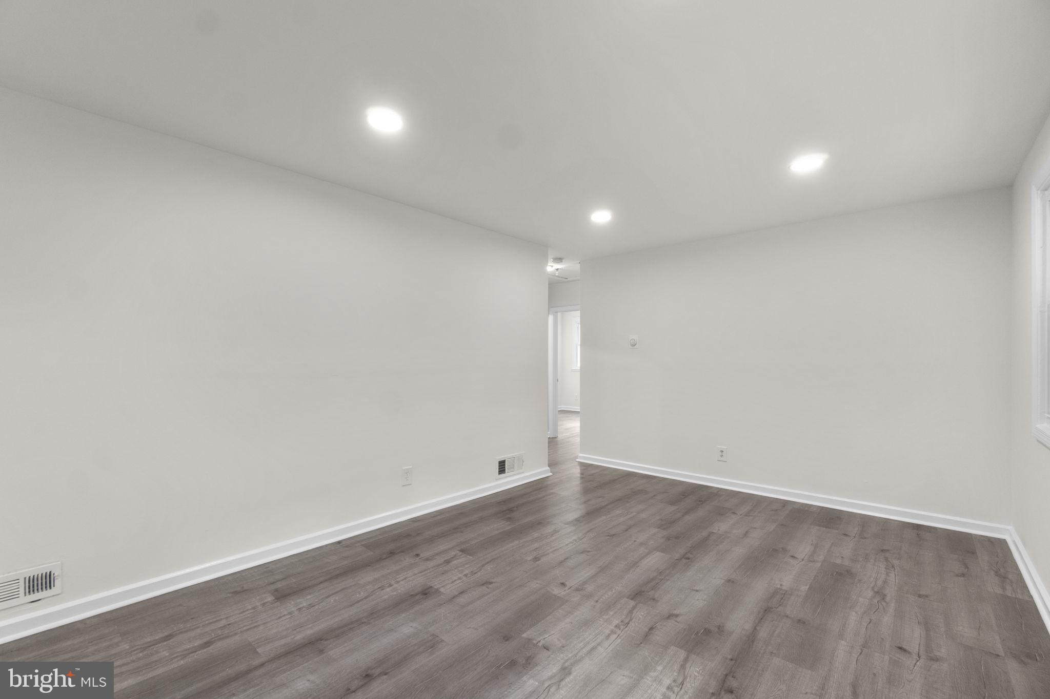 3658 Clifmar Road Baltimore, MD 21244 - Photo 10 of 43 an empty room with wooden floor and windows