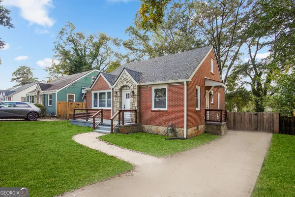 a view of a house with a yard porch and sitting area