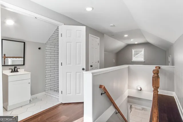 a view of a hallway with entryway and staircase