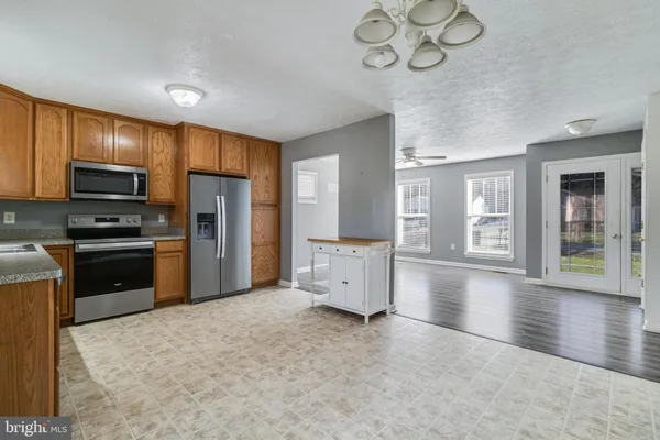 a kitchen with stainless steel appliances a refrigerator and a stove top oven