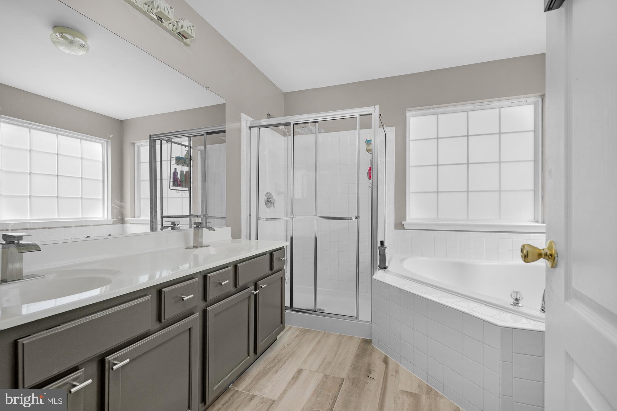 2754 Zeek Lane Lanham, MD 20706 - Photo 11 of 20 a bathroom with a tub sink and mirror