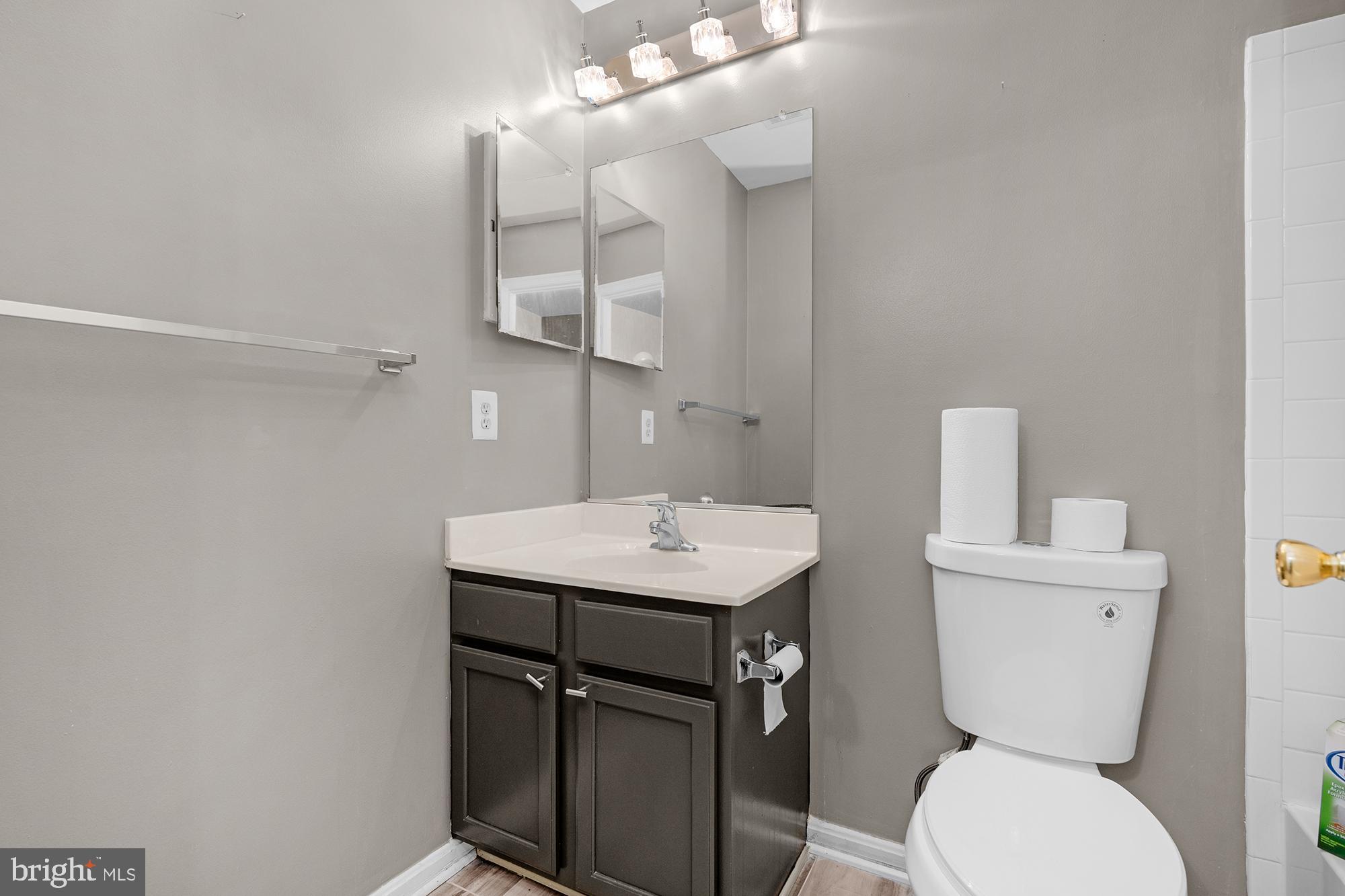 2754 Zeek Lane Lanham, MD 20706 - Photo 18 of 20 a bathroom with a toilet a sink and mirror
