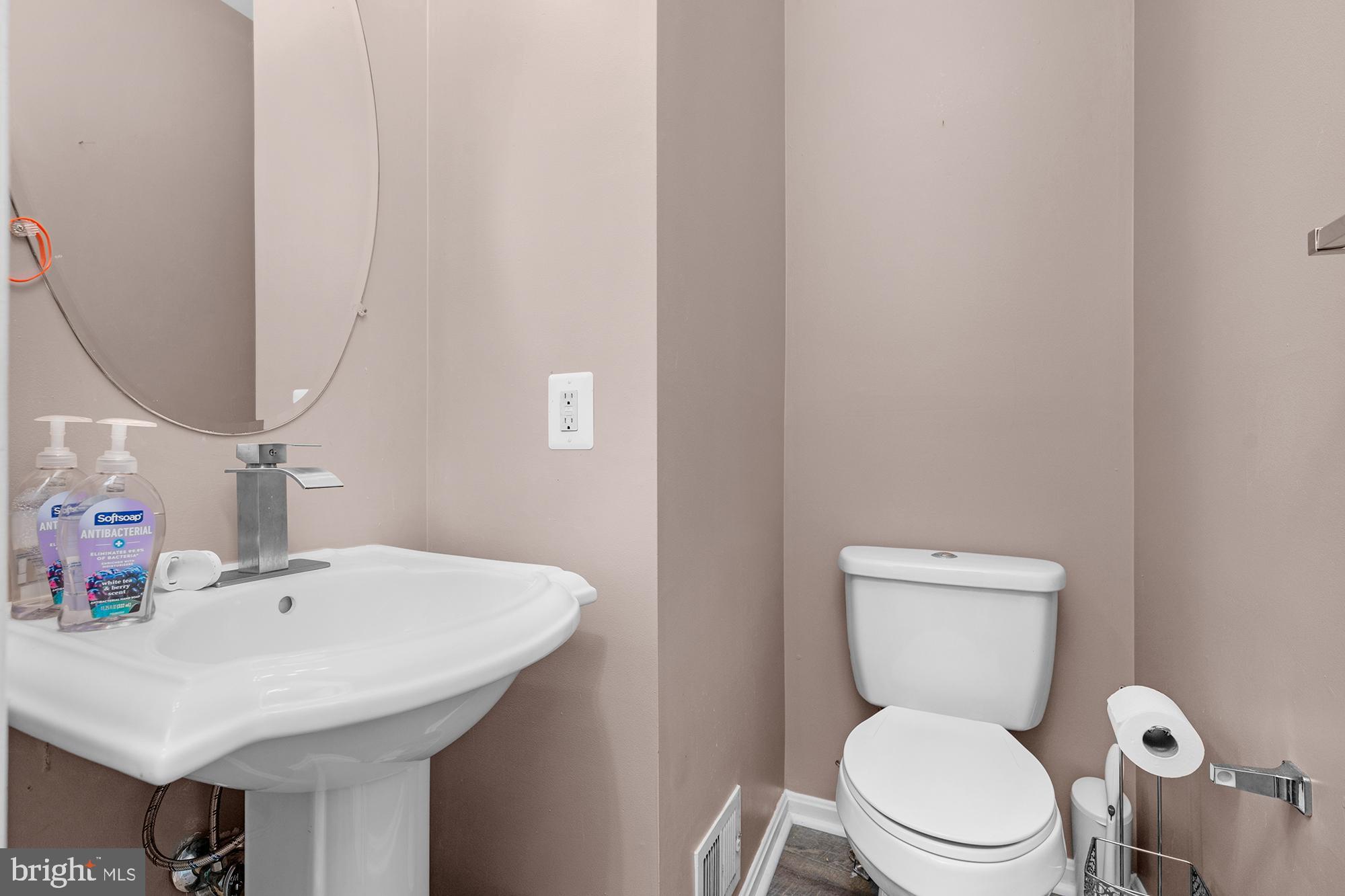 2754 Zeek Lane Lanham, MD 20706 - Photo 9 of 20 a bathroom with a sink a toilet and a mirror