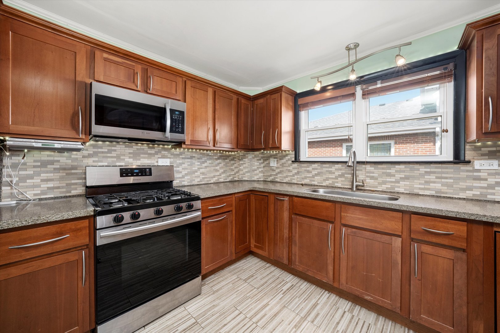 5730 West 110th Street Chicago Ridge, IL 60415 - Photo 13 of 43 a kitchen with stainless steel appliances granite countertop a stove microwave and sink