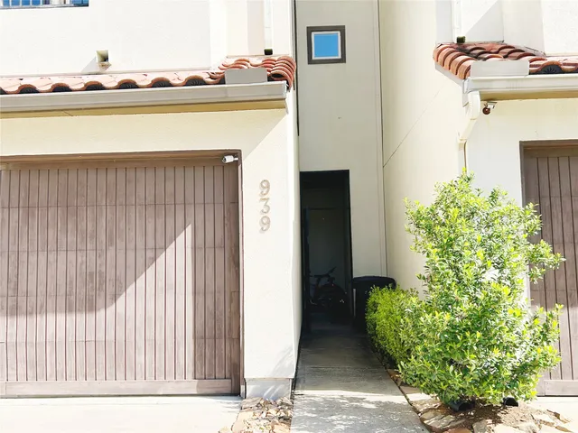 a terrace with a table and chairs and potted plants