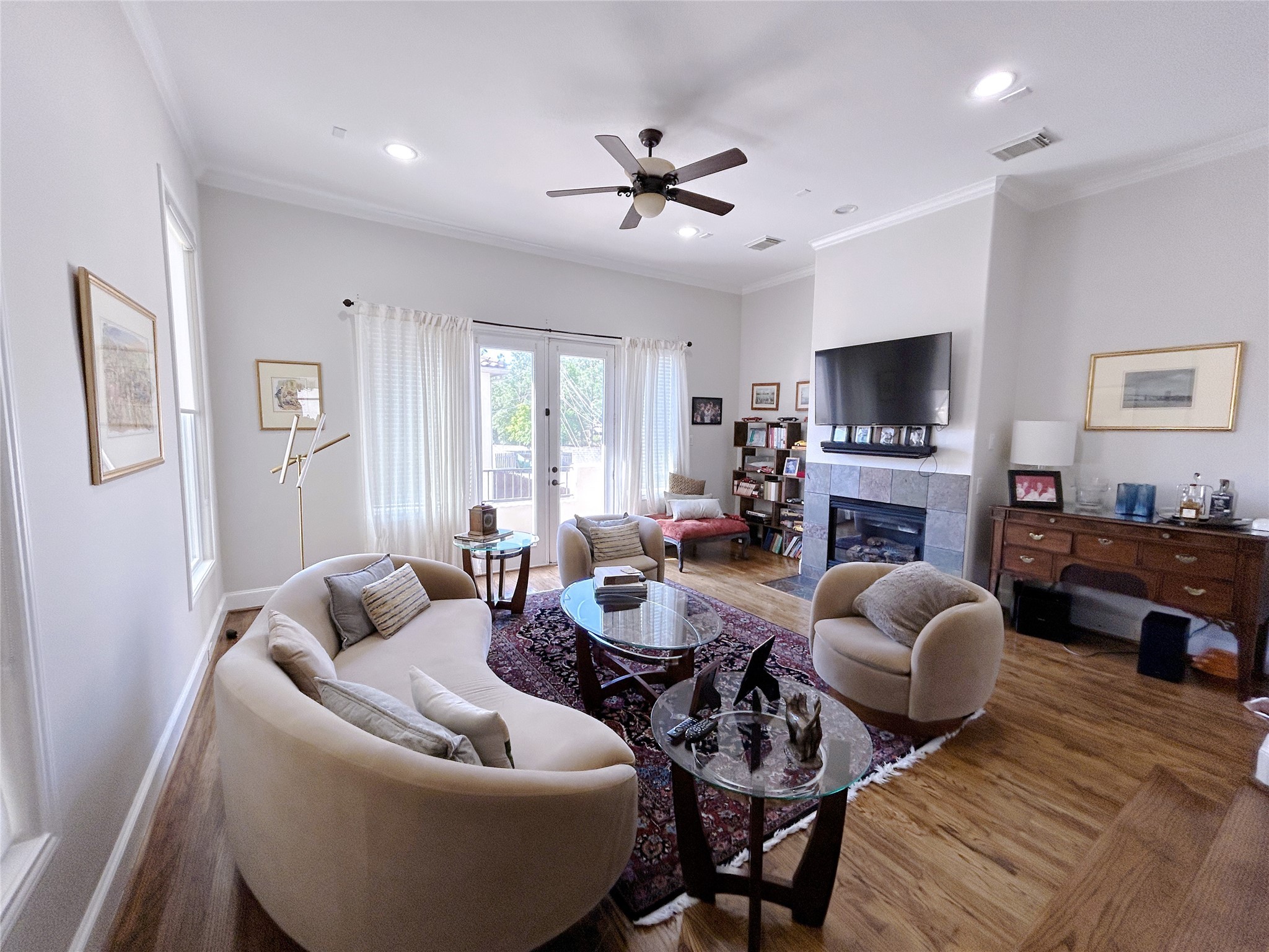 939 Queen Annes Road Houston, TX 77024 - Photo 32 of 40 a living room with furniture a fireplace and a flat screen tv
