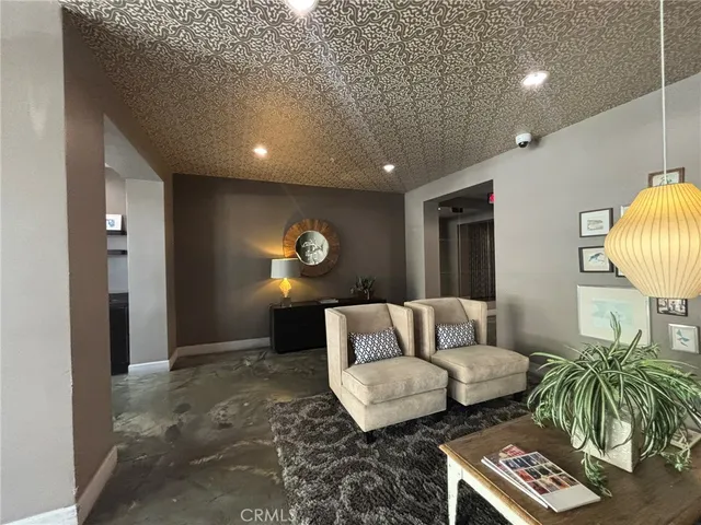 a lobby with furniture and flat screen tv
