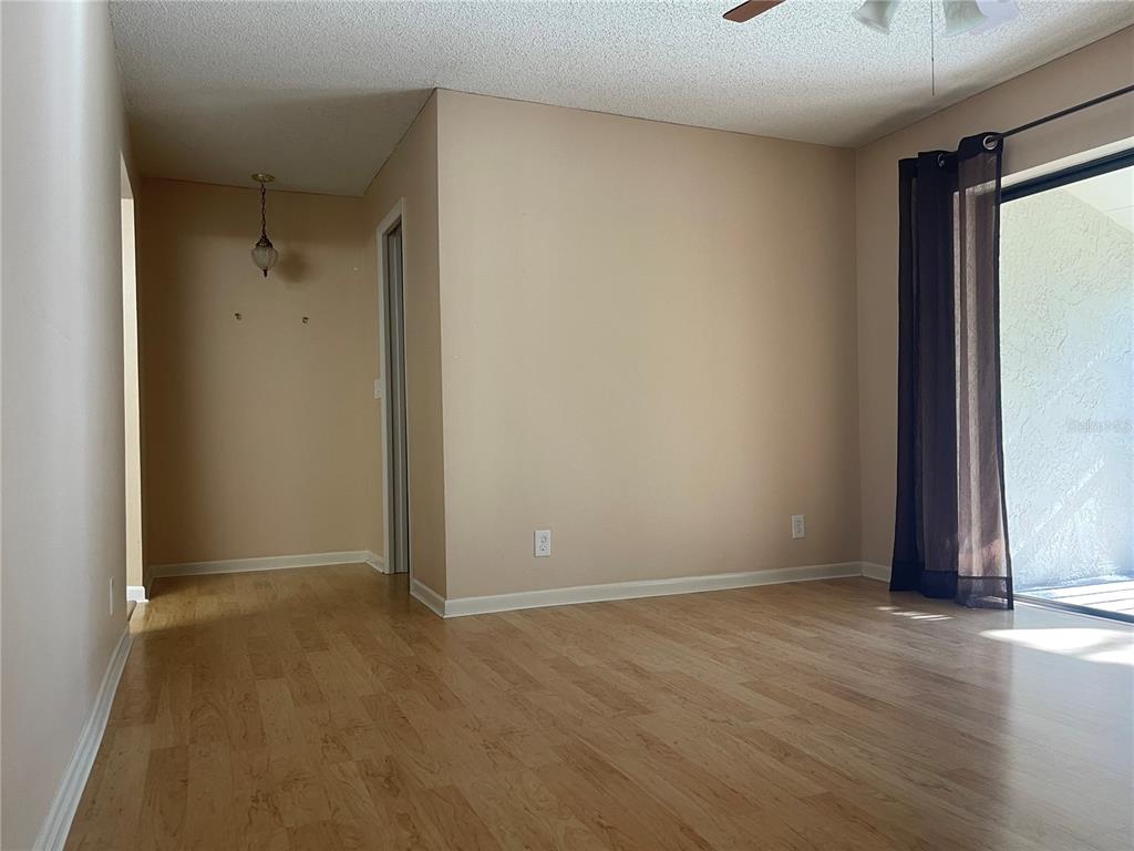 700 Starkey Road, Unit 1525 Largo, FL 33771 - Photo 13 of 46 an empty room with wooden floor and windows