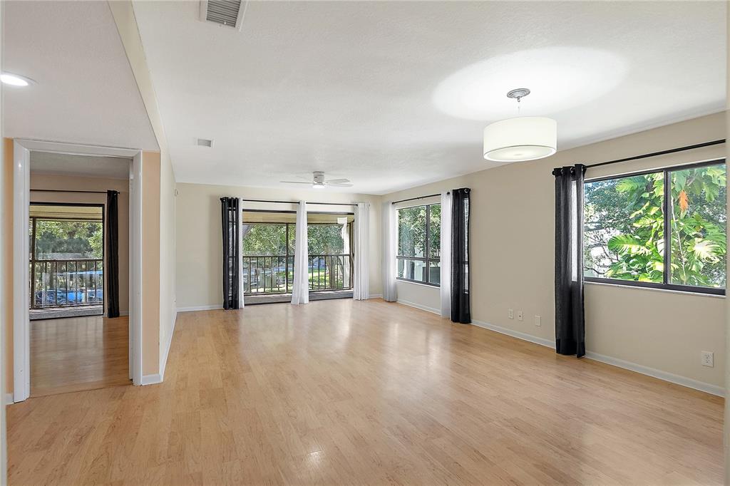 700 Starkey Road, Unit 1525 Largo, FL 33771 - Photo 2 of 46 a view of an empty room with wooden floor and a window