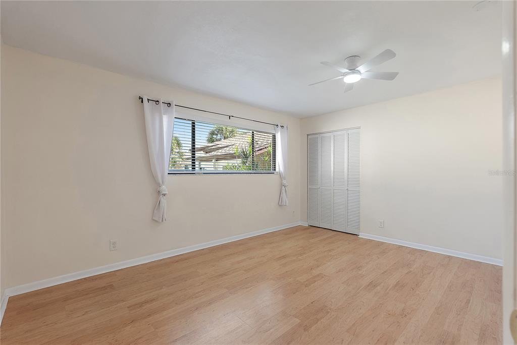 700 Starkey Road, Unit 1525 Largo, FL 33771 - Photo 27 of 46 a view of an empty room with wooden floor and a window