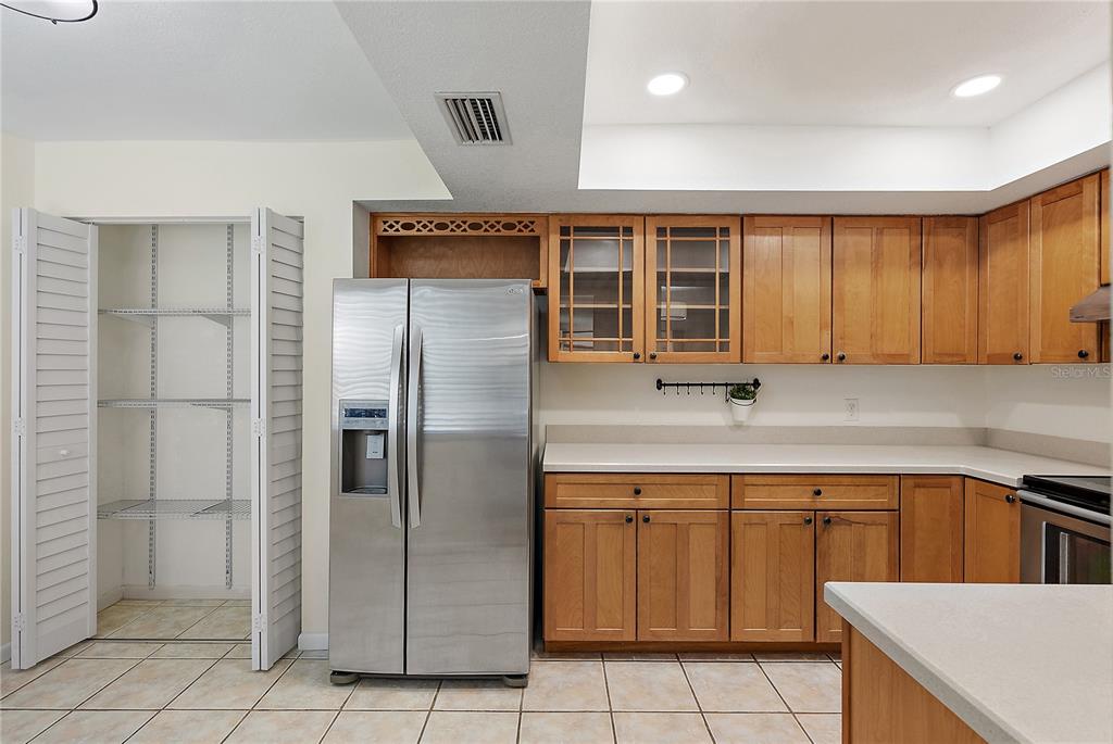700 Starkey Road, Unit 1525 Largo, FL 33771 - Photo 5 of 46 a kitchen with a sink a refrigerator and cabinets