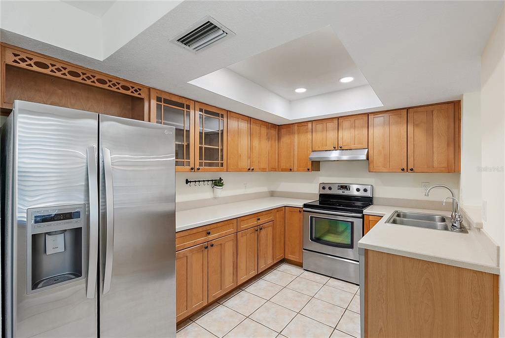 700 Starkey Road, Unit 1525 Largo, FL 33771 - Photo 6 of 46 a kitchen with stainless steel appliances granite countertop a refrigerator stove top oven a sink and dishwasher