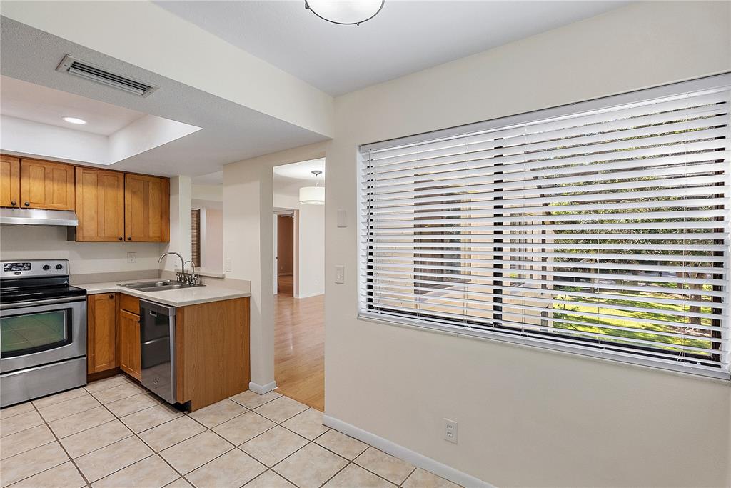 700 Starkey Road, Unit 1525 Largo, FL 33771 - Photo 10 of 46 a kitchen with stainless steel appliances granite countertop a stove and a sink