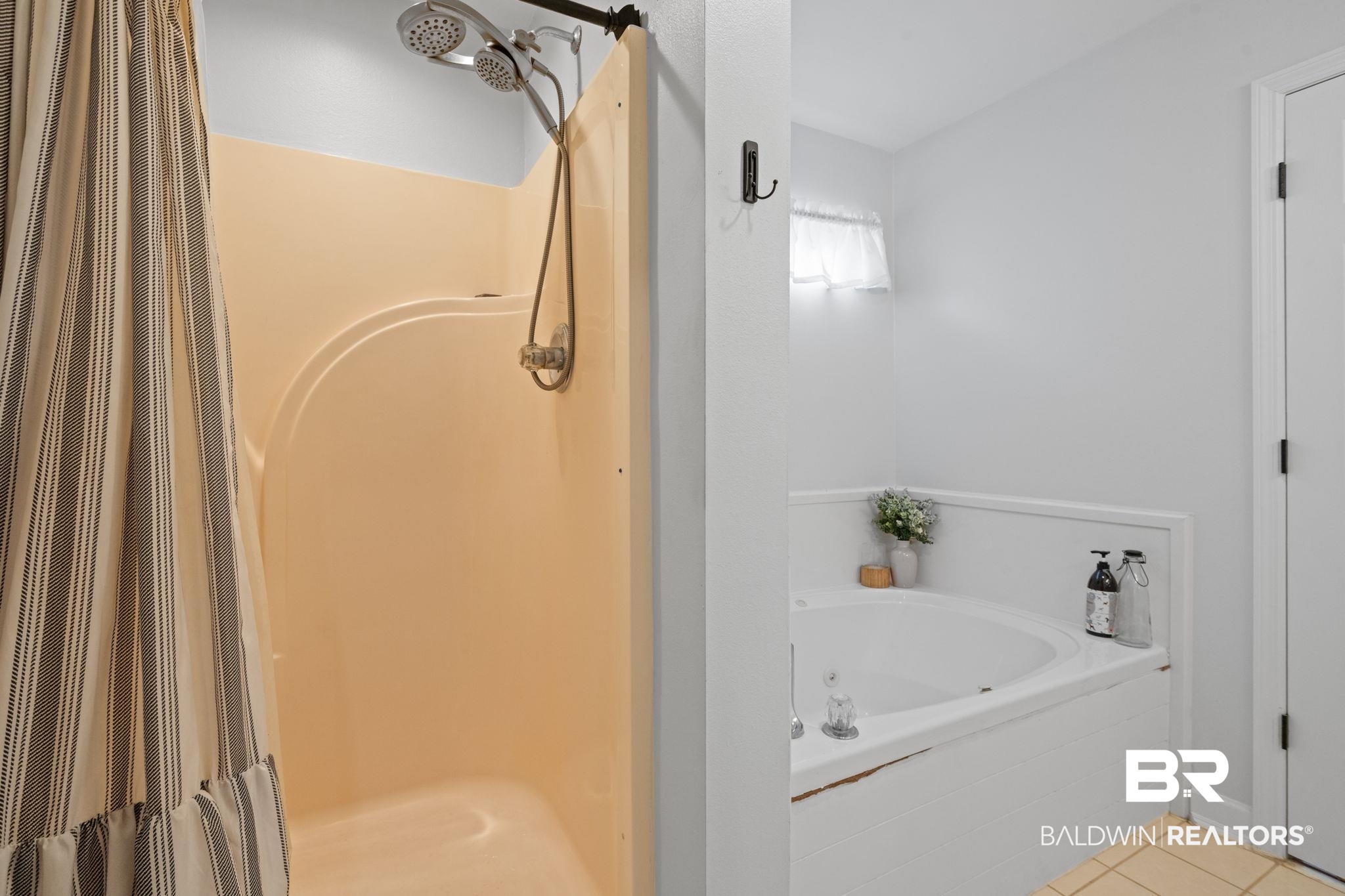 5936 Lundy Road Theodore, AL 36582 - Photo 15 of 32 Bathroom featuring a built-in corner soaking tub with a tiled surround, a separate shower stall with a dual shower head system, and light-colored wall paint