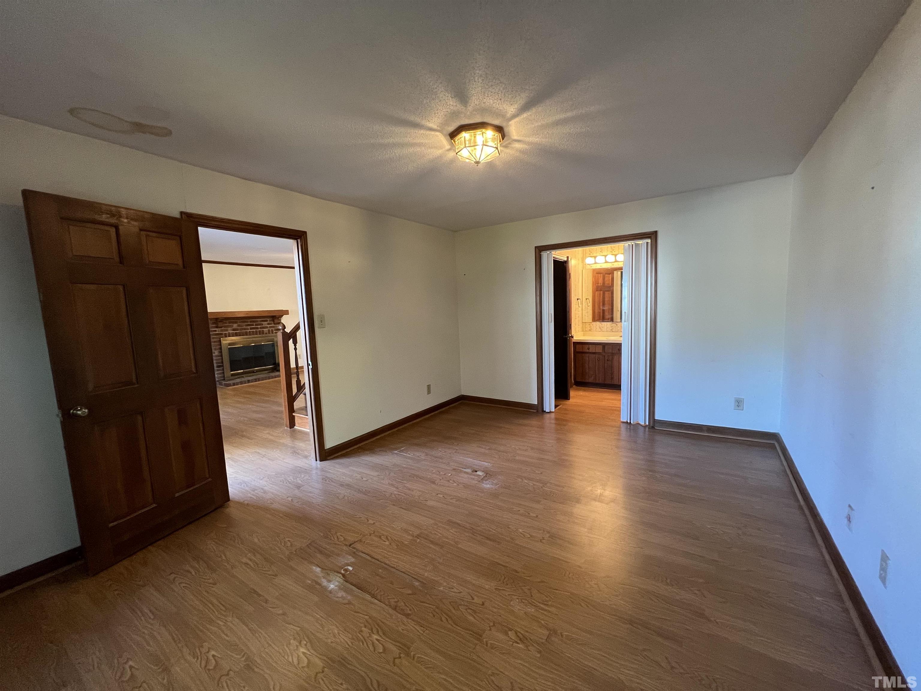 2509 Sawmill Road Raleigh, NC 27613 - Photo 3 of 22 an empty room with closet and wooden floor