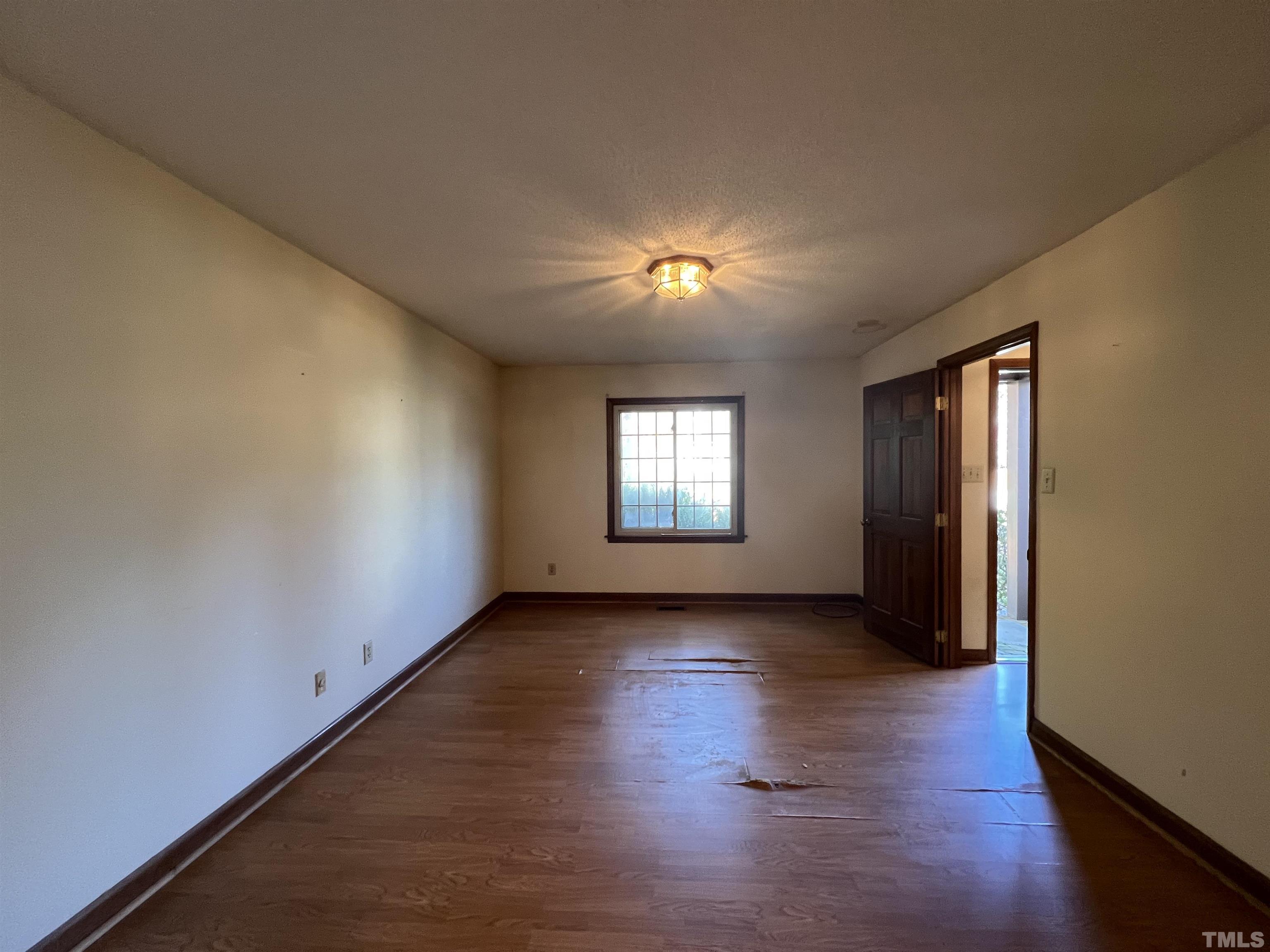 2509 Sawmill Road Raleigh, NC 27613 - Photo 7 of 22 an empty room with wooden floor and windows