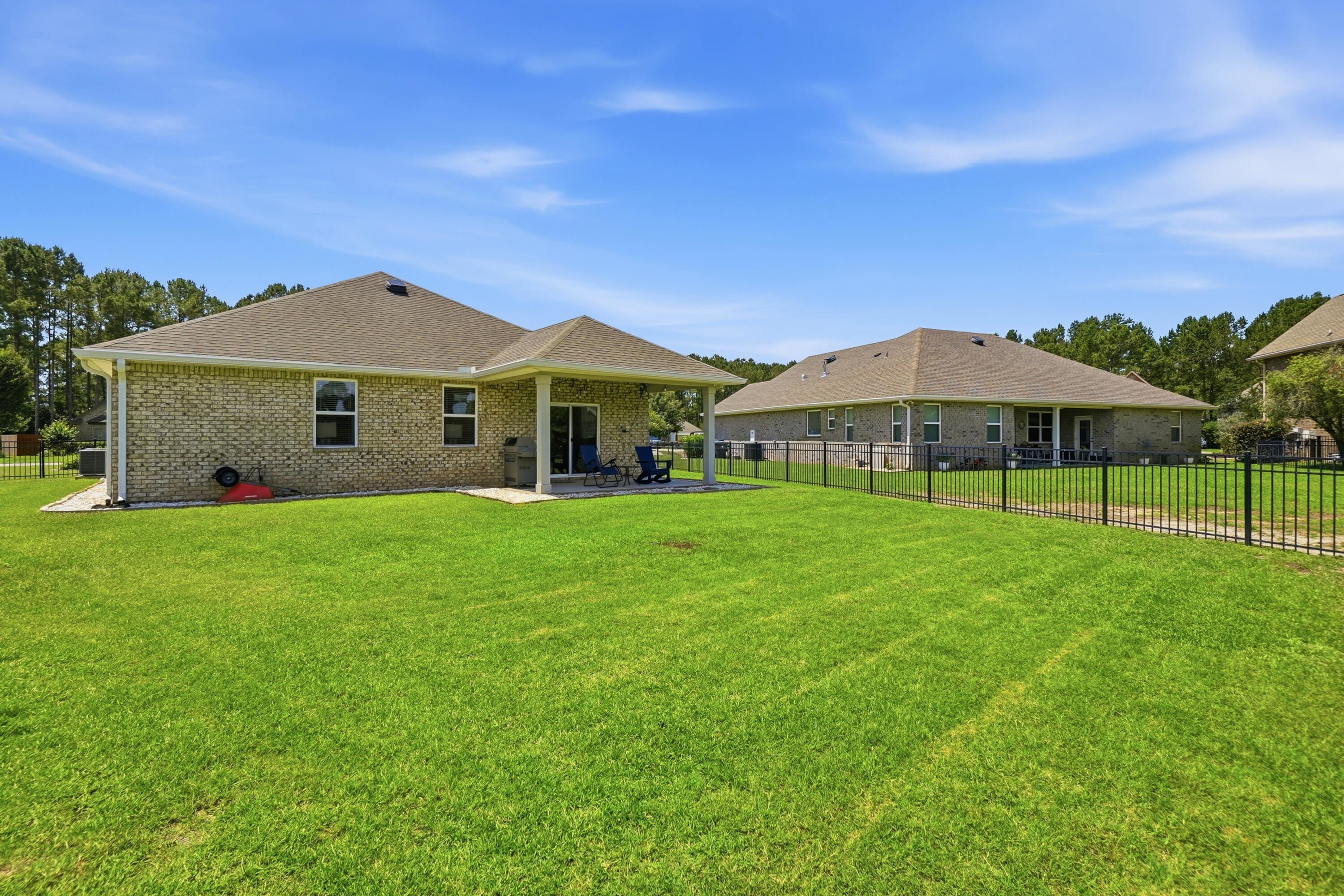 525 Windchime Way Freeport, FL 32439 - Photo 38 of 59 a front view of a house with garden
