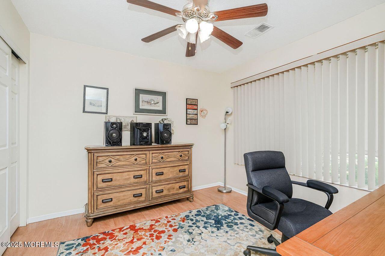 35 Ivy Ridge Close Freehold, NJ 07728 - Photo 13 of 18 a bedroom with a bed and a chair