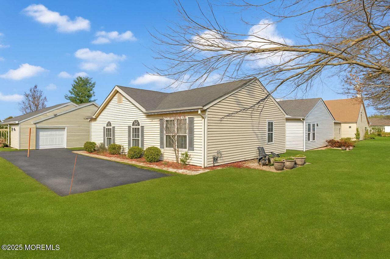 35 Ivy Ridge Close Freehold, NJ 07728 - Photo 17 of 18 a view of a white house with a yard and garage