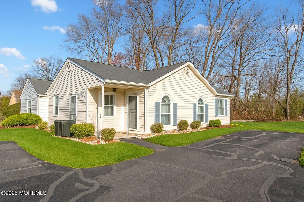 35 Ivy Ridge Close Freehold, NJ 07728 - Photo 18 of 18 a front view of a house with a yard and trees