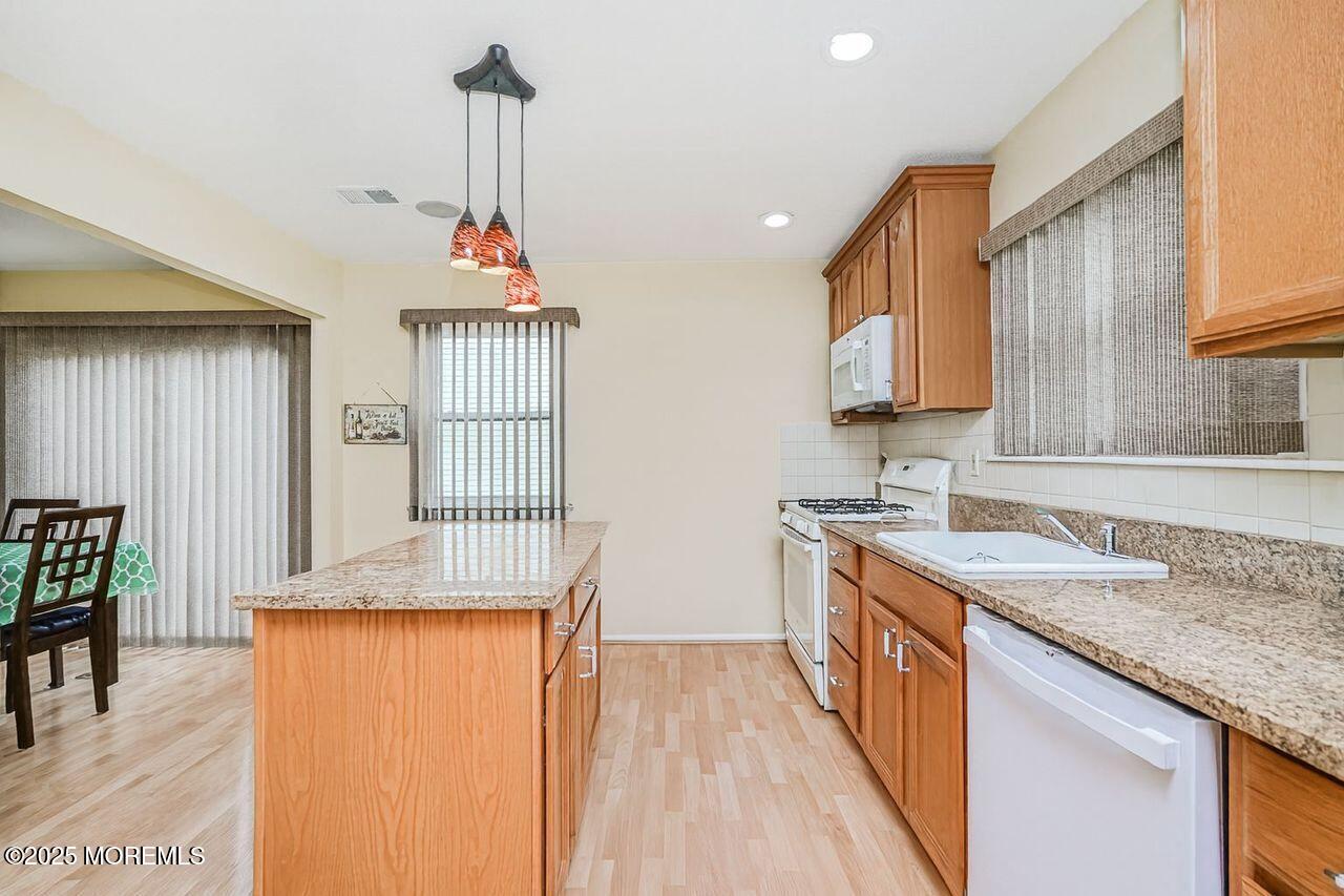 35 Ivy Ridge Close Freehold, NJ 07728 - Photo 7 of 18 a kitchen with sink refrigerator and window
