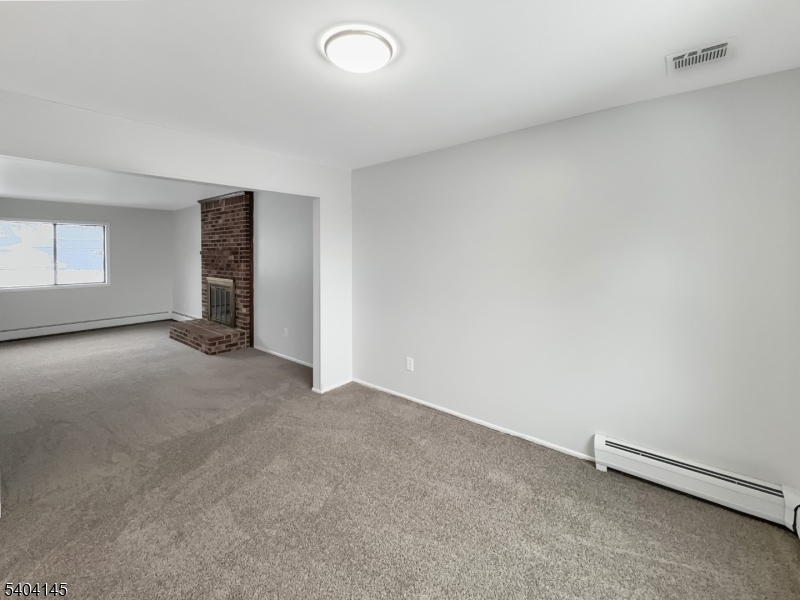 16 Knob Hill Road Hackettstown, NJ 07840 - Photo 12 of 41 an empty room with a empty space and windows