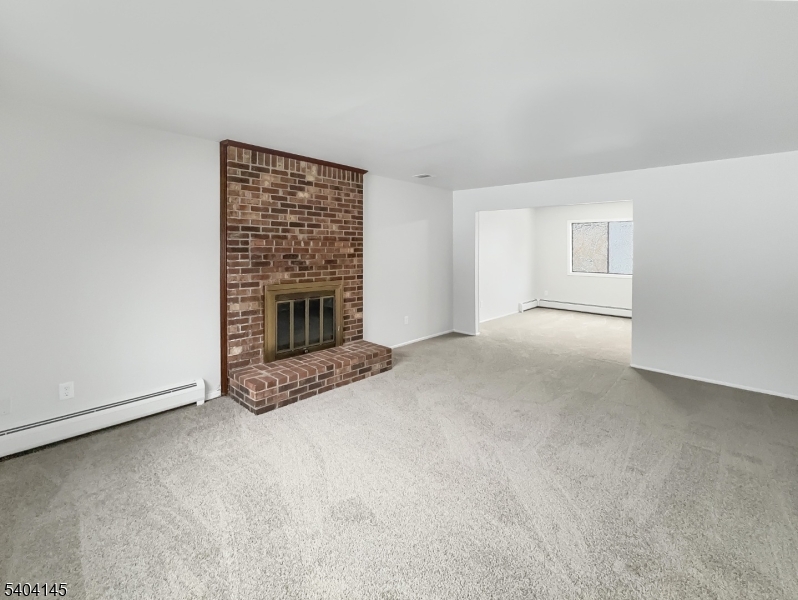 16 Knob Hill Road Hackettstown, NJ 07840 - Photo 13 of 41 a view of an empty room with a fireplace and a window