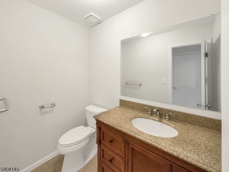 16 Knob Hill Road Hackettstown, NJ 07840 - Photo 15 of 41 a bathroom with a granite countertop sink a toilet and a mirror