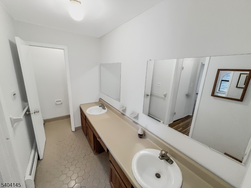 16 Knob Hill Road Hackettstown, NJ 07840 - Photo 22 of 41 a bathroom with a double vanity sink and mirror