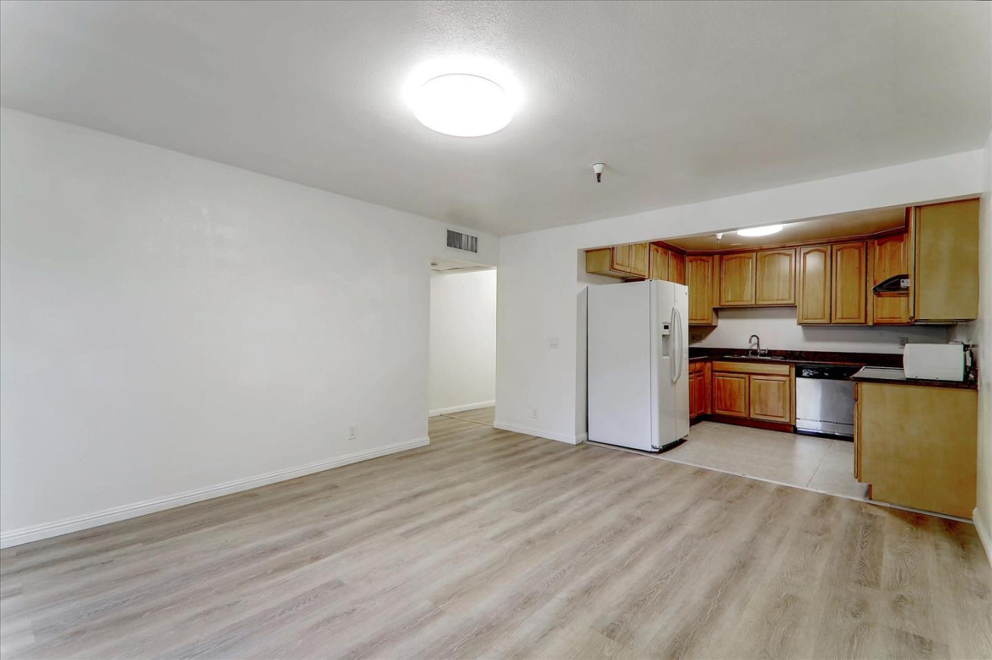 1775 Panda Way, Unit 103 Hayward, CA 94541 - Photo 14 of 33 a view of kitchen with stainless steel appliances wooden floor and a refrigerator