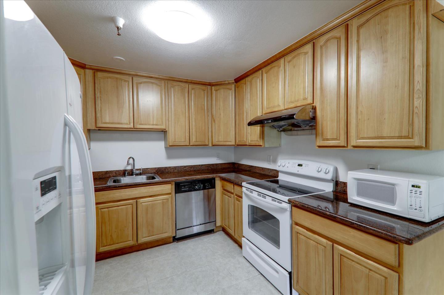 1775 Panda Way, Unit 103 Hayward, CA 94541 - Photo 17 of 33 a kitchen with a sink stove and cabinets