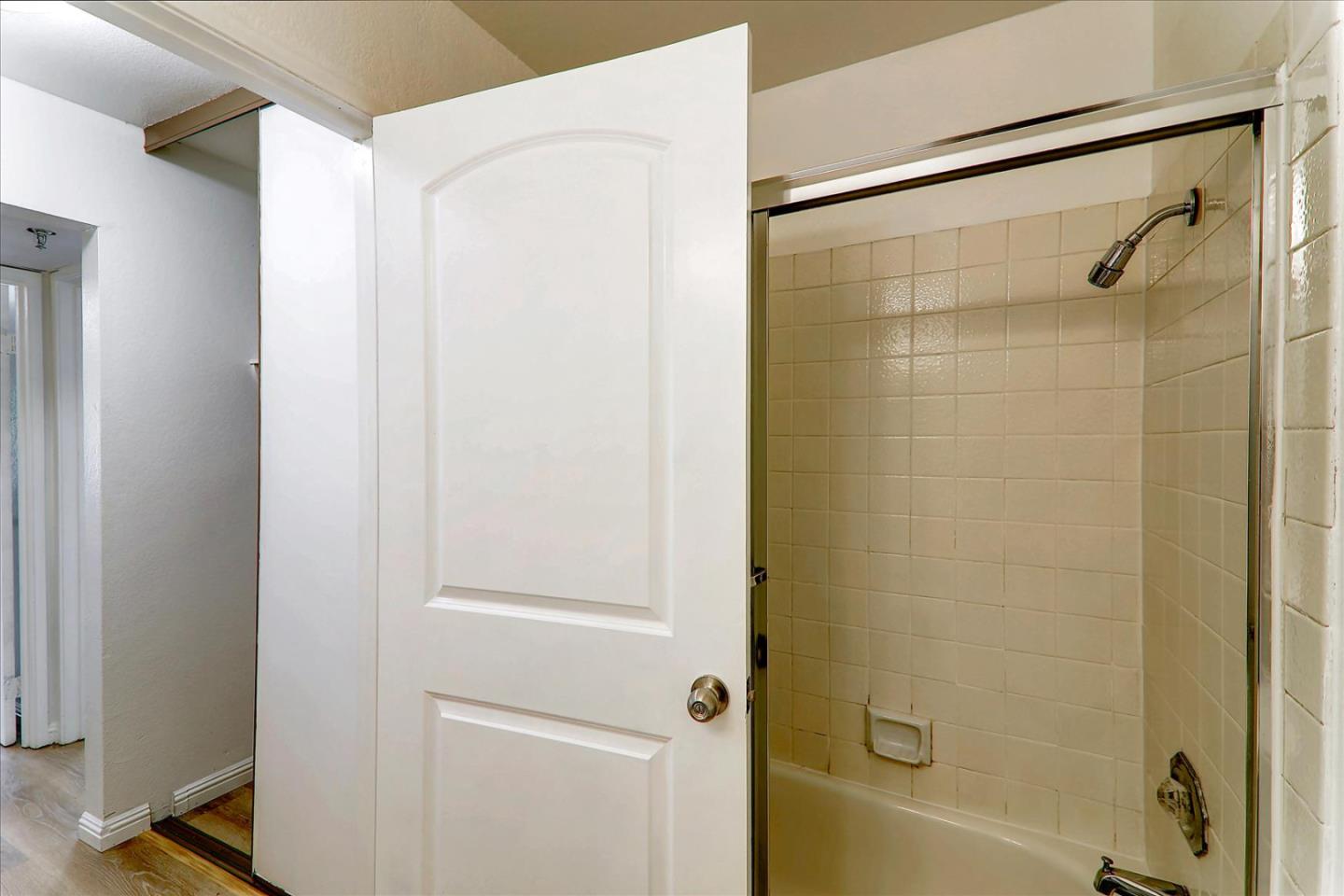 1775 Panda Way, Unit 103 Hayward, CA 94541 - Photo 24 of 33 a bathroom with a glass shower door