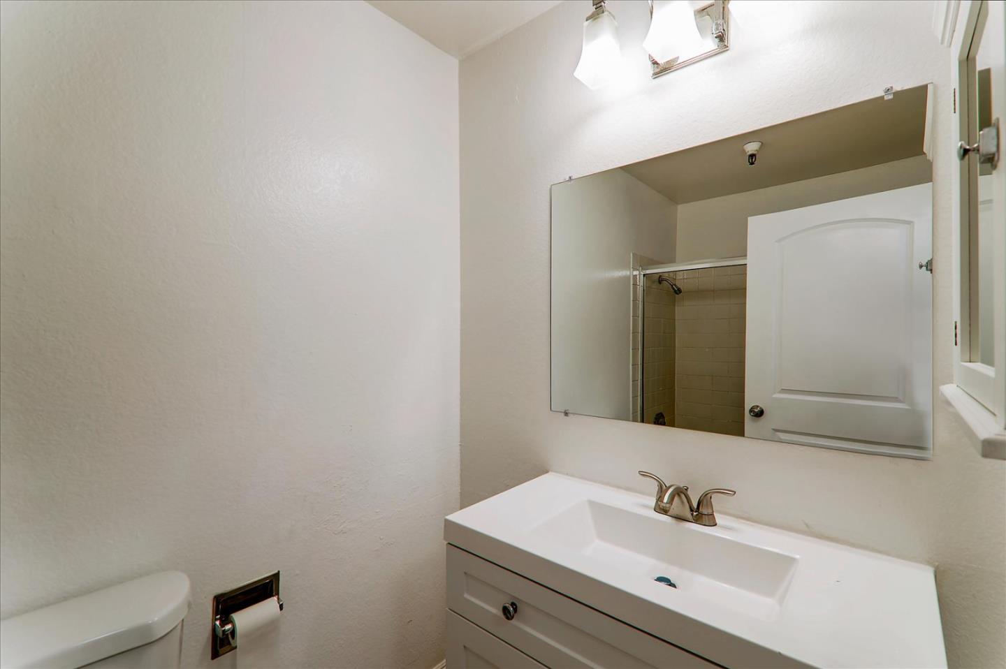 1775 Panda Way, Unit 103 Hayward, CA 94541 - Photo 25 of 33 a bathroom with a sink and a mirror