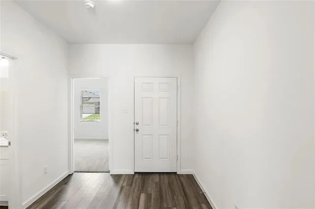 a view of a room with wooden floor